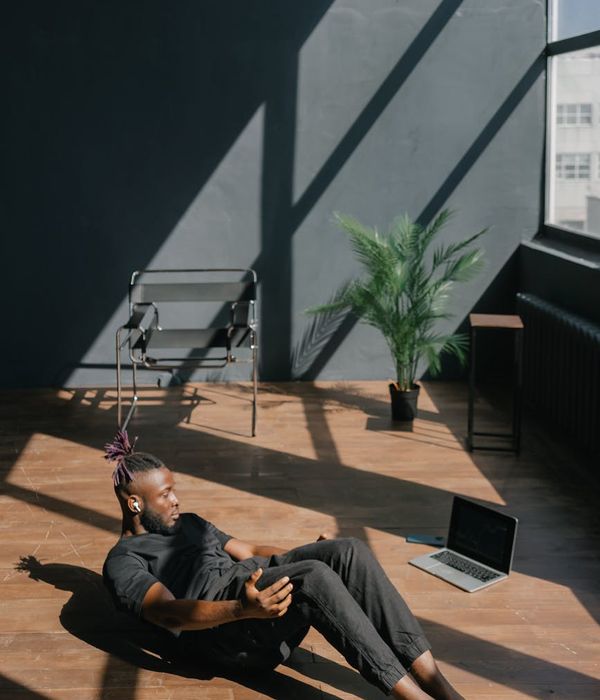 Focused man performing a core stability exercise in a bright, clean space.